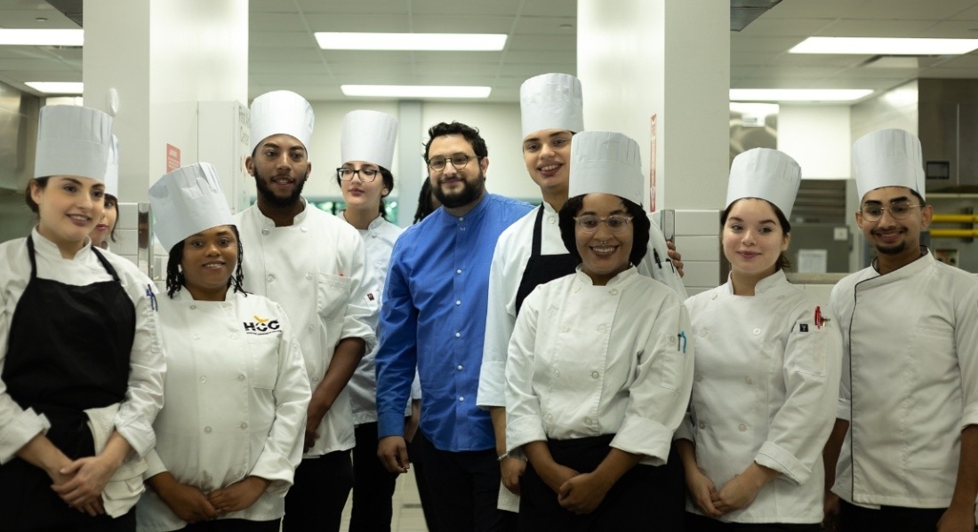 HCC chef, restaurateur alum Felipe Riccio, center, poses with current HCC Culinary Arts students during a visit to HCC Central Campus.