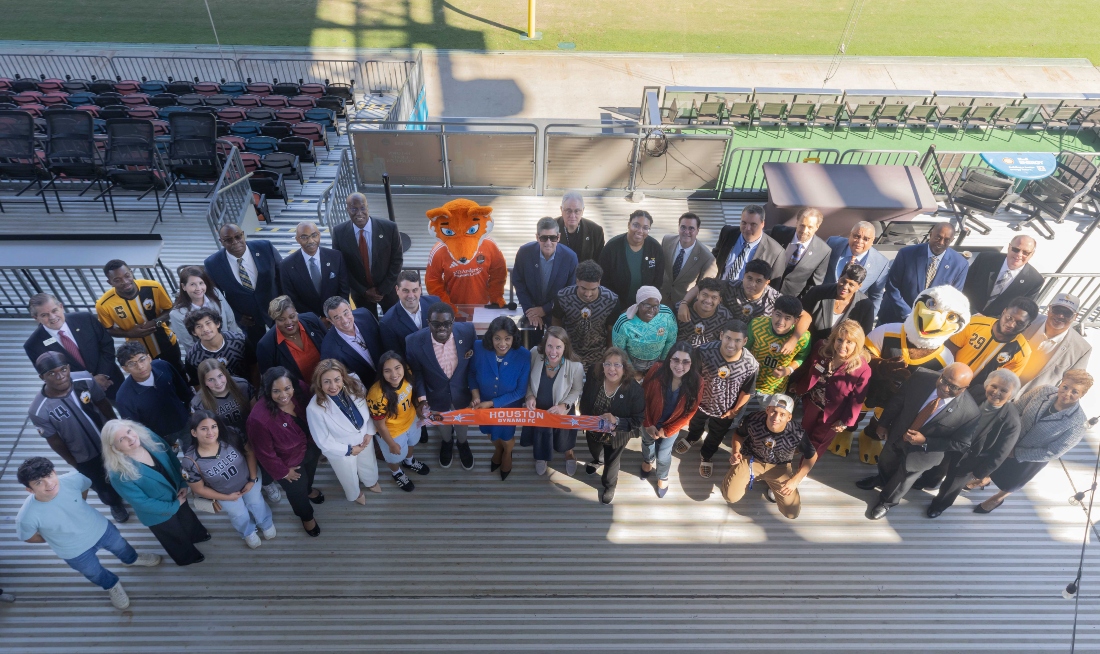 HCC students and officials pose for a photo at Shell Energy Stadium.