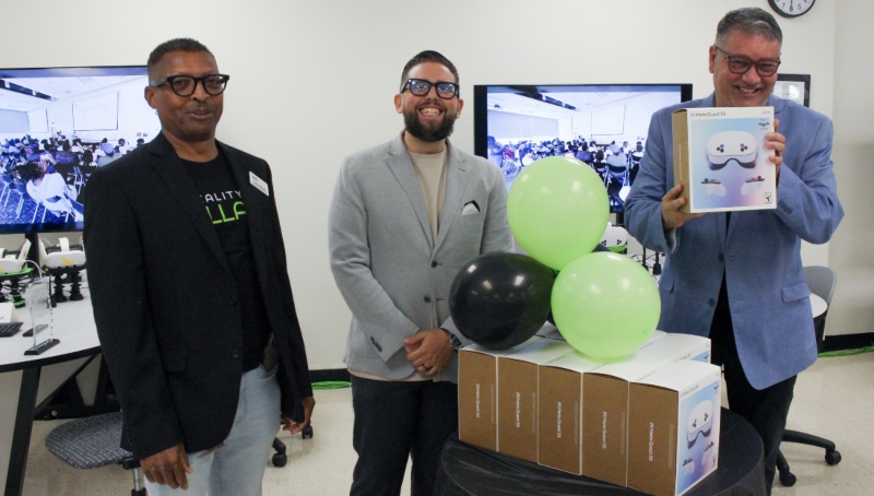 Lynden Marshall, Reality COLLAB Media, Visual and Performing Arts Support Specialist; Carlos Figarella of Meta Reality Labs; and Rubén Durán, HCC Reality COLLAB co-founder, pose with one of the 10 Meta Quest headsets donated to Houston City College.